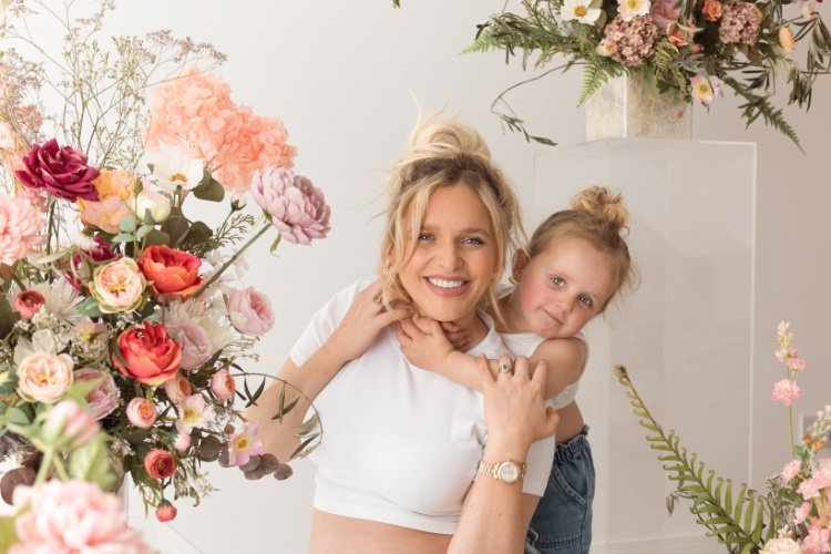 Booking a family photoshoot in West Malling, Kent with a mother and daughter between posed flowers