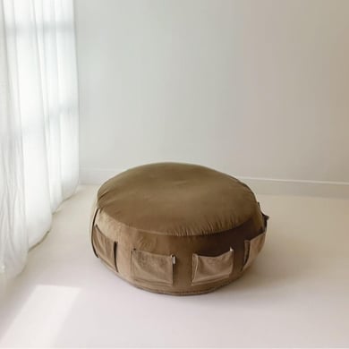 Photograph of a cushion within a newborn photography studio where a baby can lay and roll around in a square shape